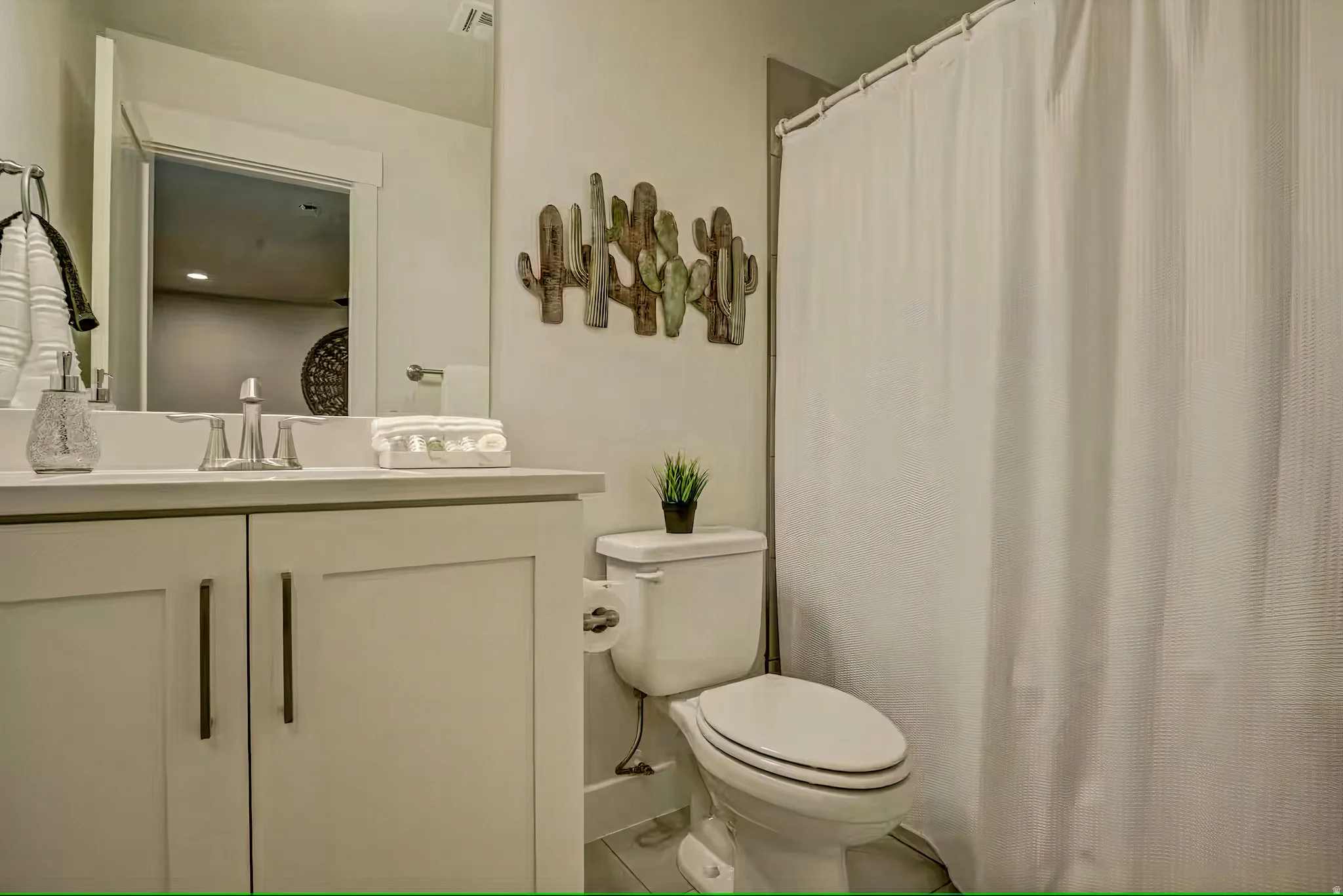 Full bath featuring vanity and curtained shower