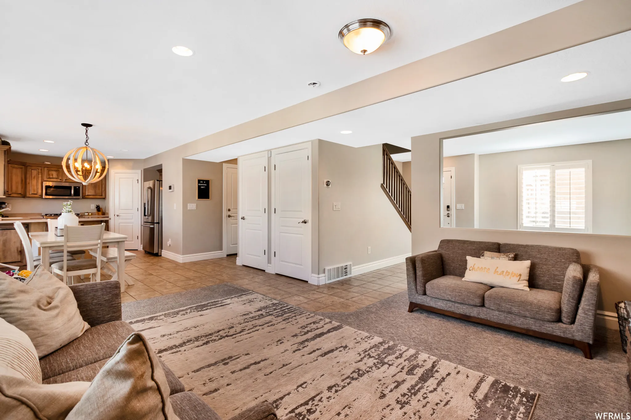 Living area featuring hanging lights and light tile patterned floors