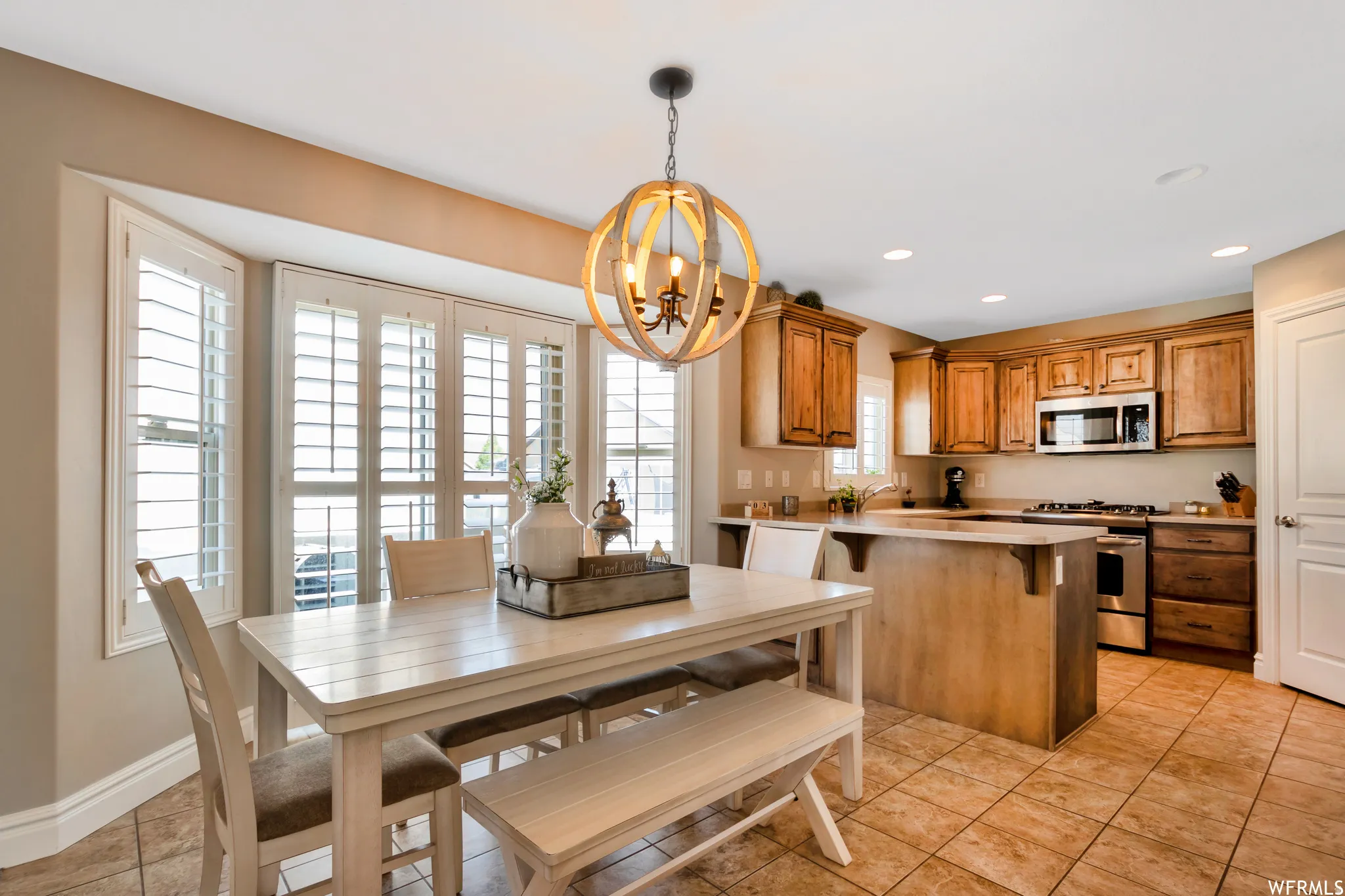 Dining space featuring a chandelier and light tile patterned floors