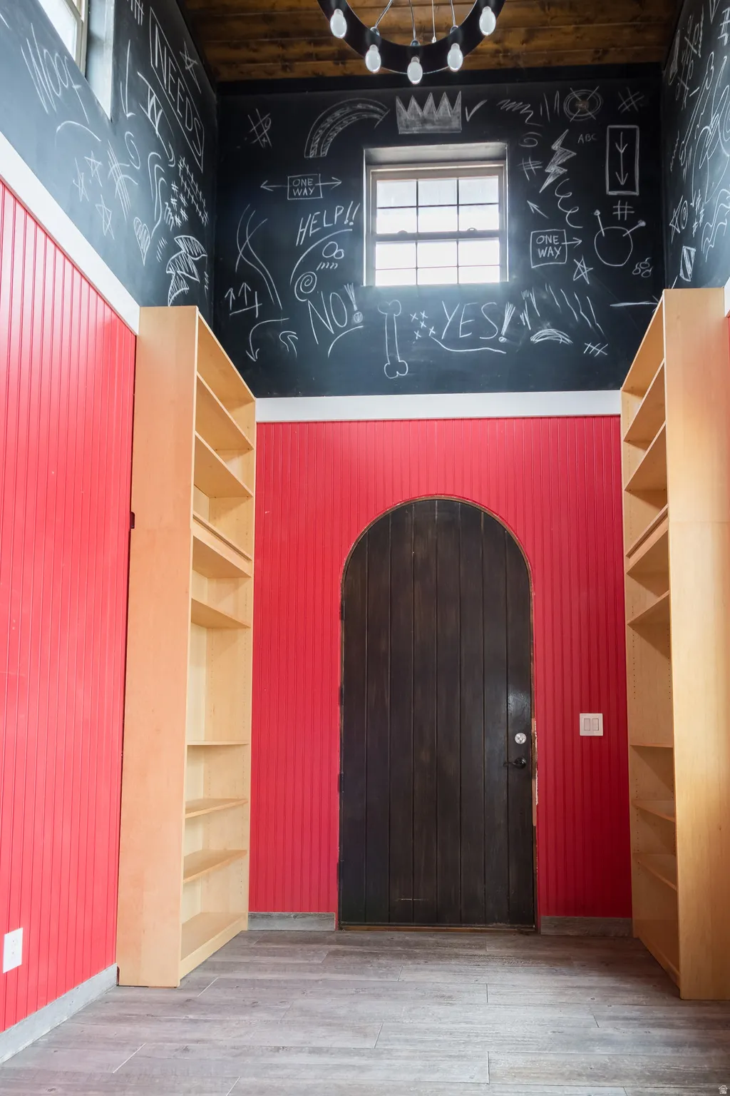 Foyer entrance featuring wood finished floors, a high ceiling, and arched walkways