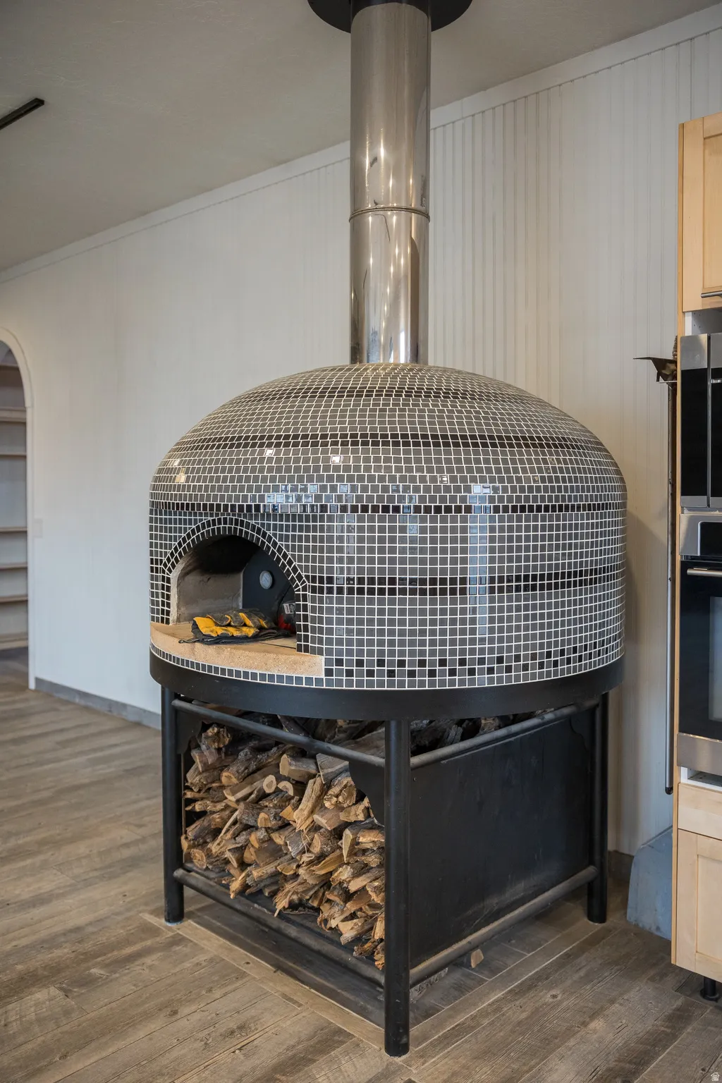 Detailed view of wood finished floors, oven, and ornamental molding