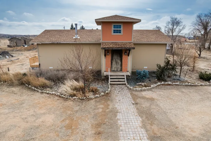 View of front of home with a shingled roof