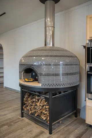 Detailed view of wood tile finished floors, pizza oven, and ornamental molding
