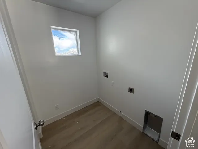 Bright interior with light wood-finish flooring and a square window