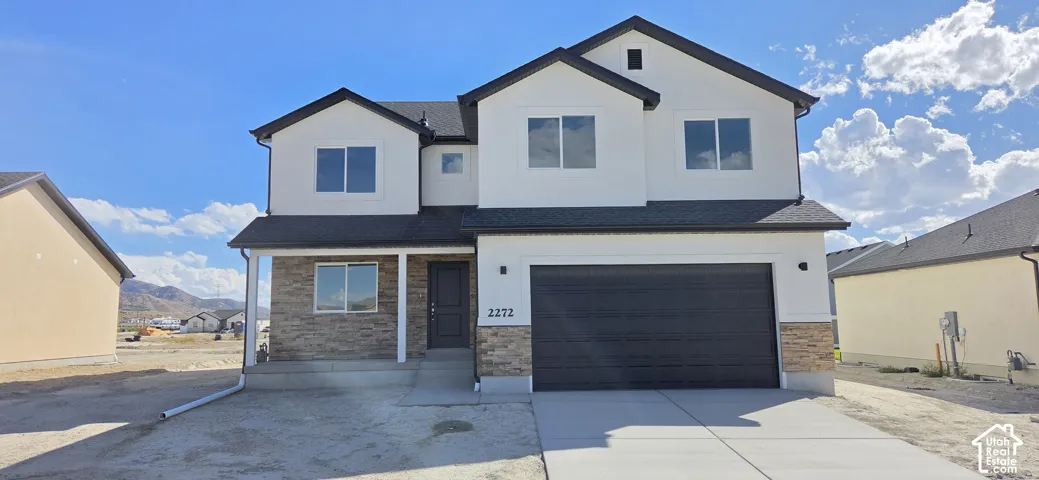 Contemporary exterior featuring white stucco and stone veneer accents