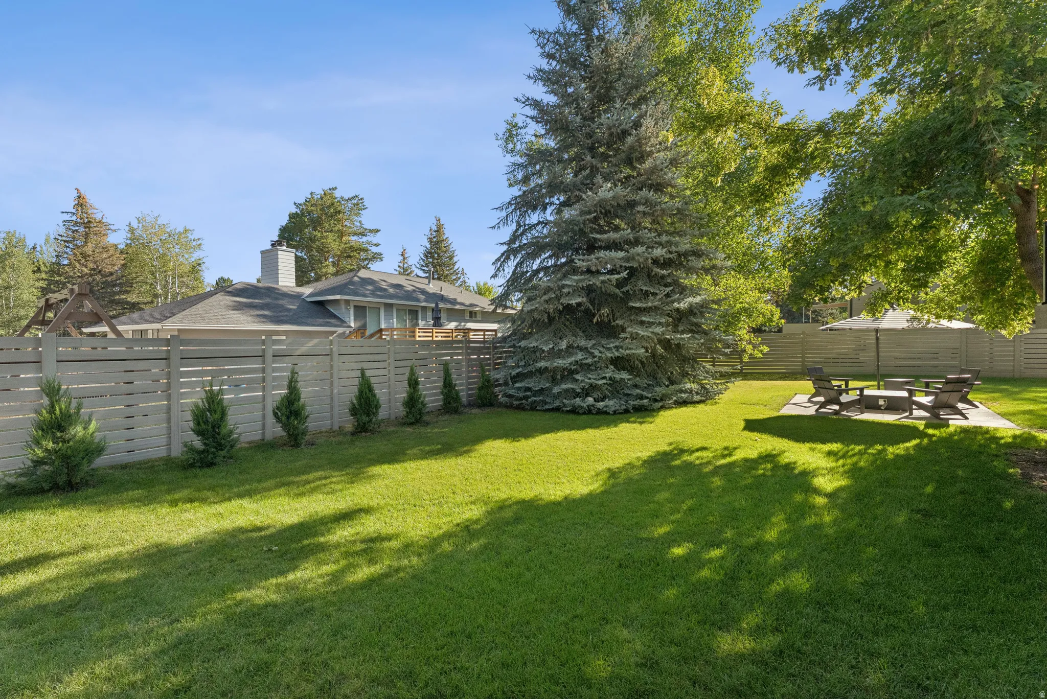 Fenced backyard with a patio