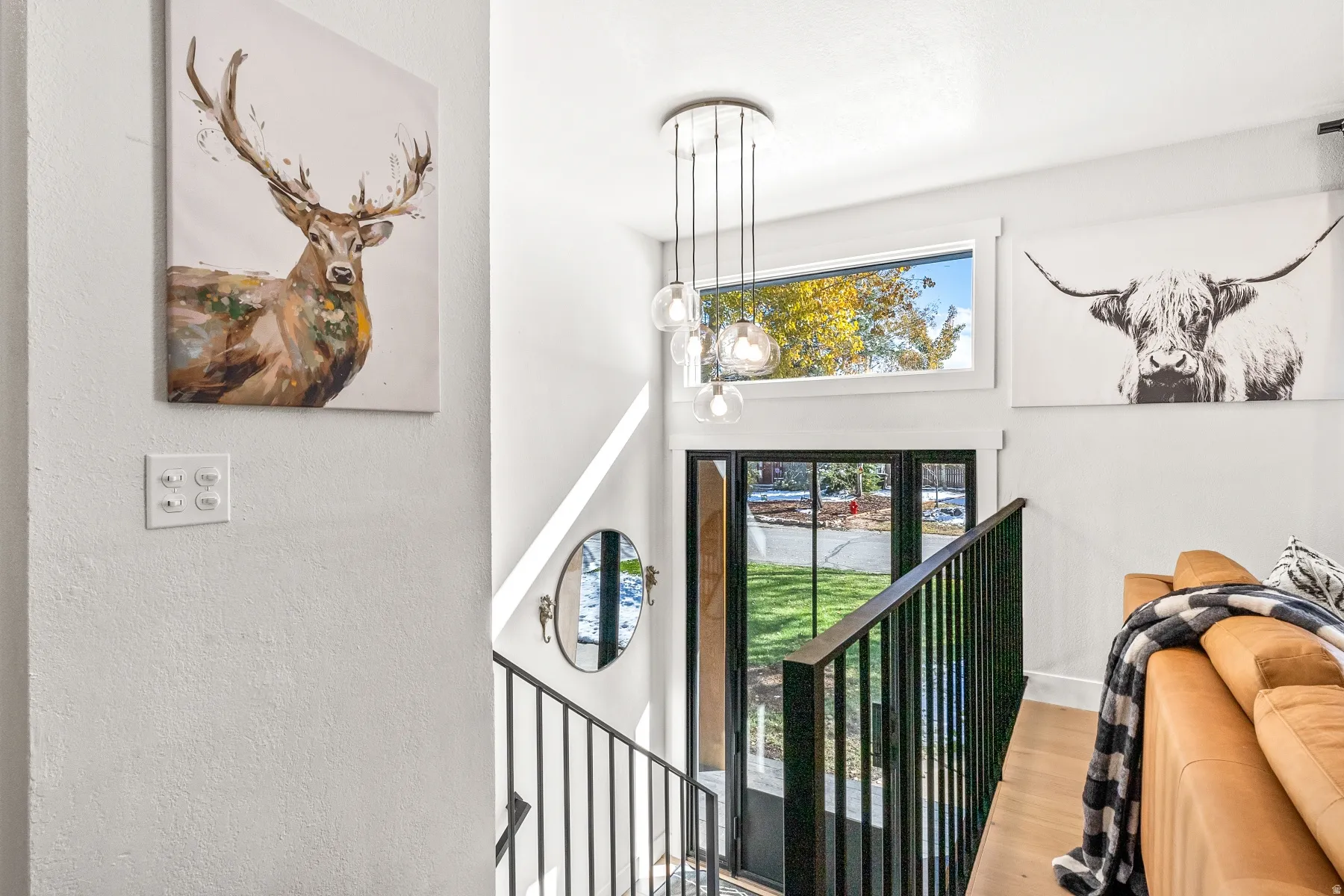 Foyer with wood finished floors and a high ceiling