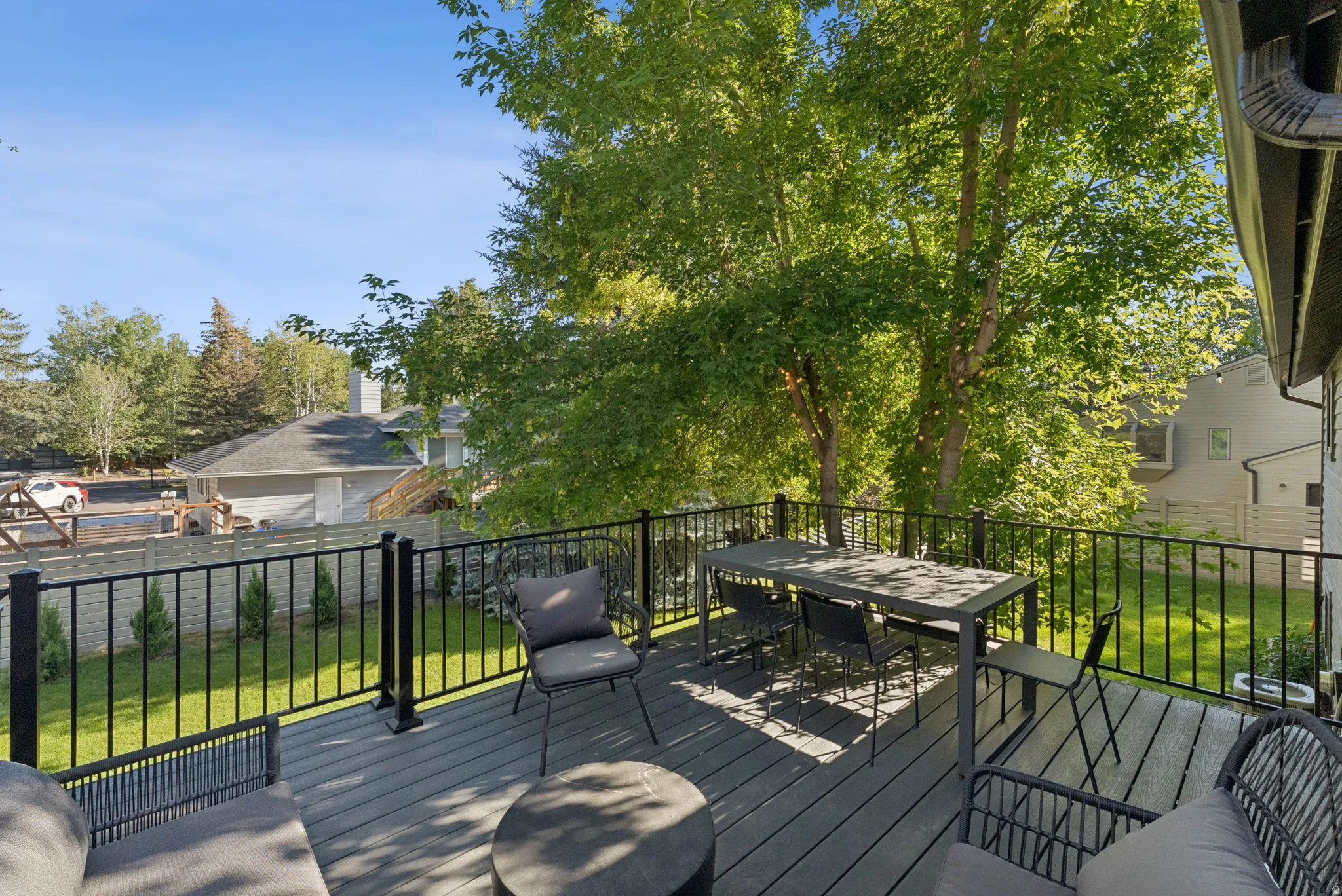 Wooden terrace with a lawn and outdoor dining space
