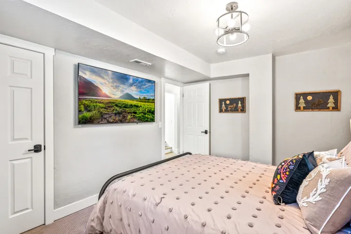 Bedroom with carpet floors, a textured wall, and a textured ceiling