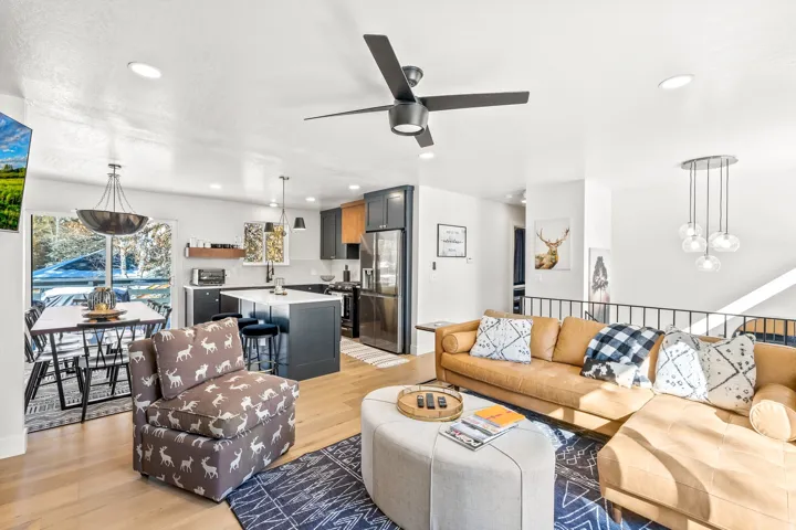 Living room featuring light wood finished floors, a ceiling fan, and recessed lighting