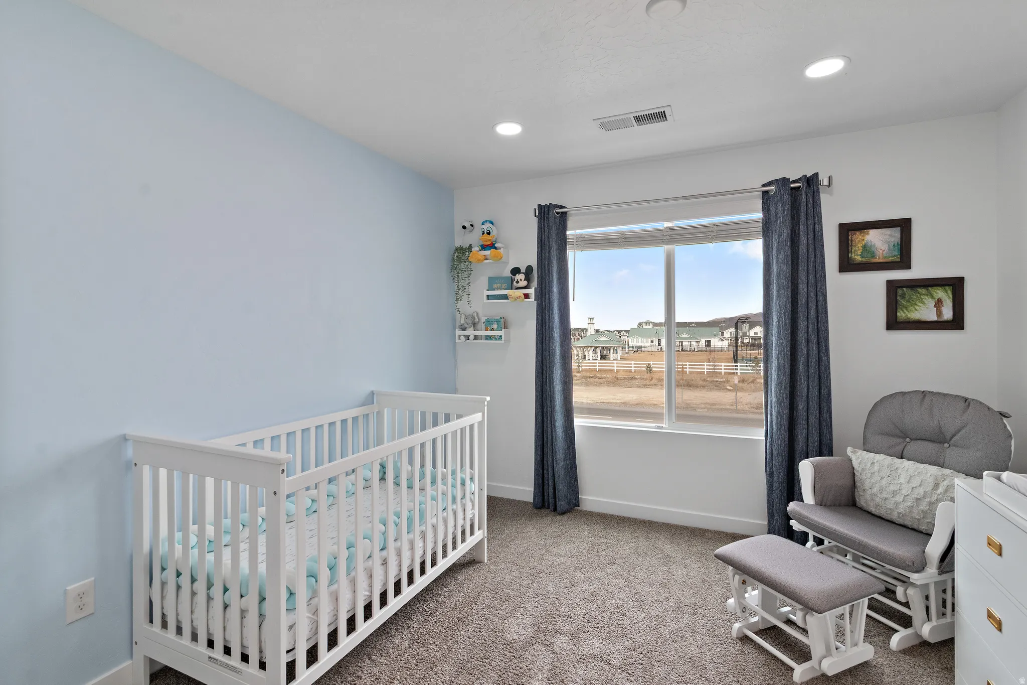 Bedroom featuring a crib, carpet floors, and recessed lighting