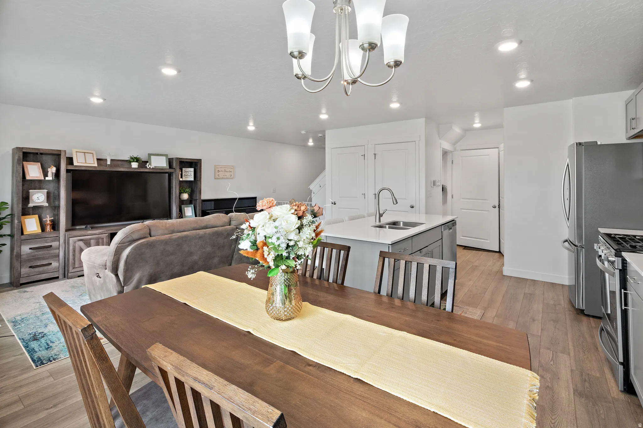 Dining space with light wood-style floors and a chandelier