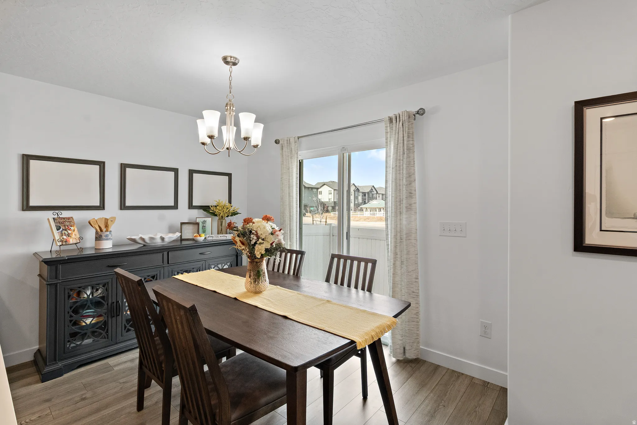 Dining space featuring light wood-style floors and suspended lighting