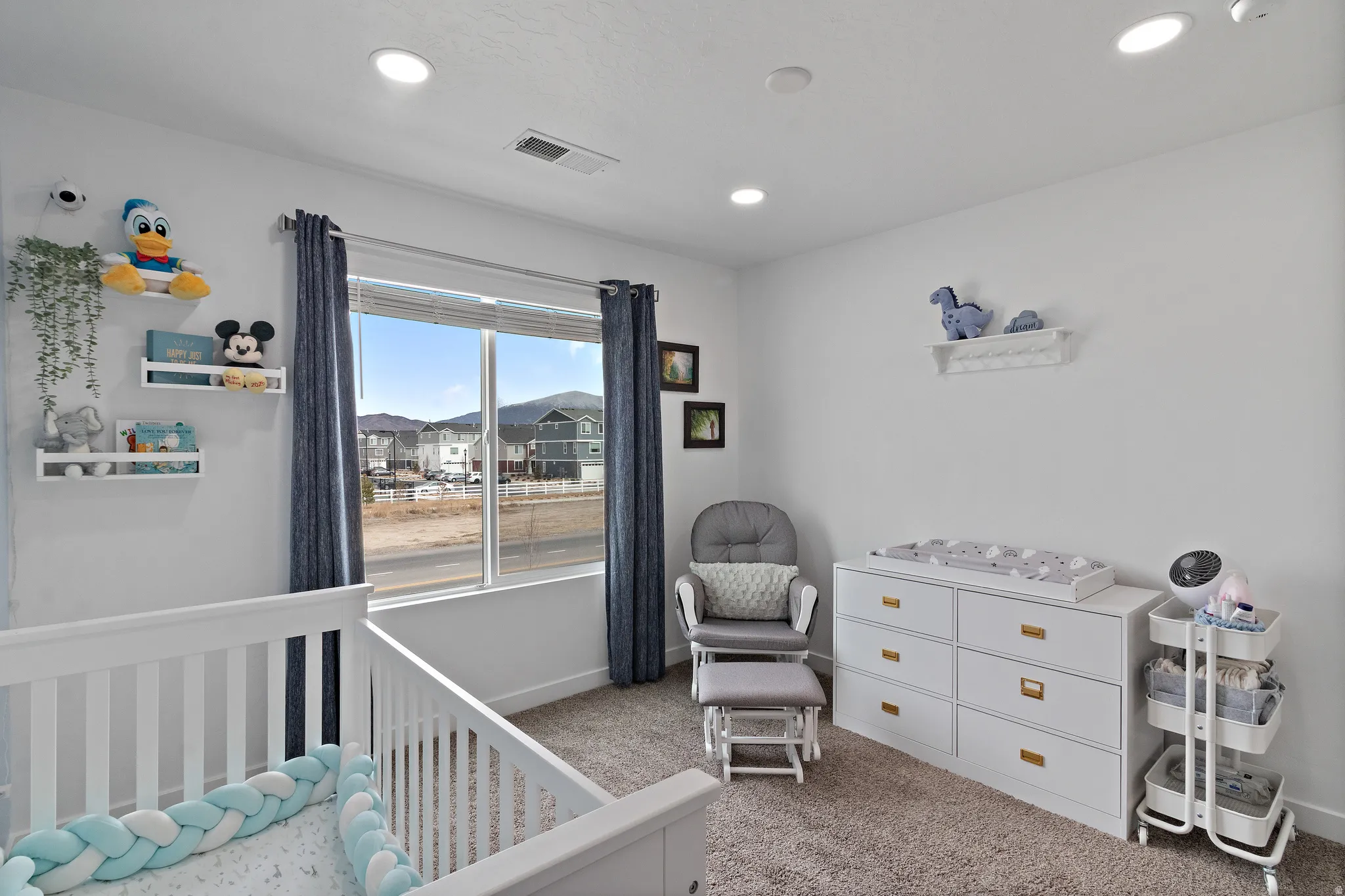 Bedroom featuring carpet floors, a crib, and recessed lighting