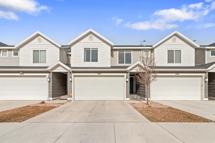 View of front of home with a garage and driveway