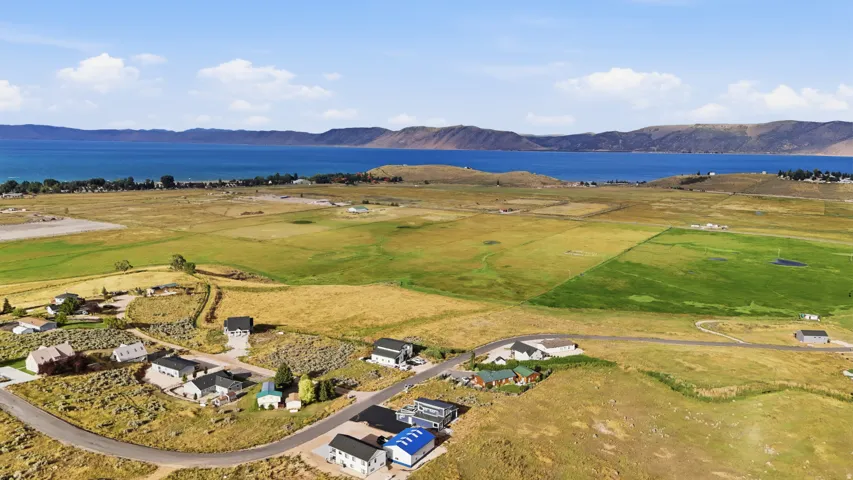 Expansive natural landscape with a prominent body of water and distant mountains