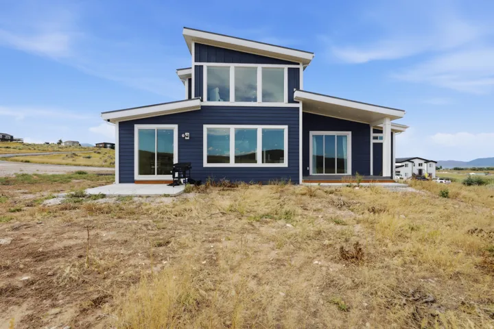 Contemporary exterior with dark blue siding and white trim