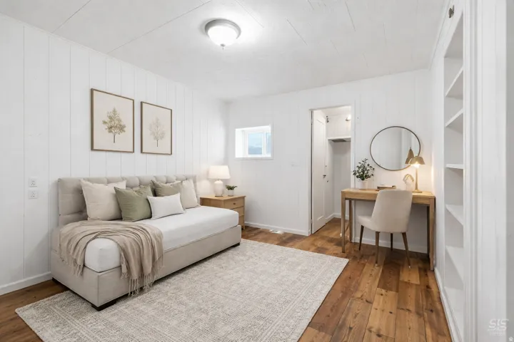 Bedroom featuring dark wood-type flooring and baseboards