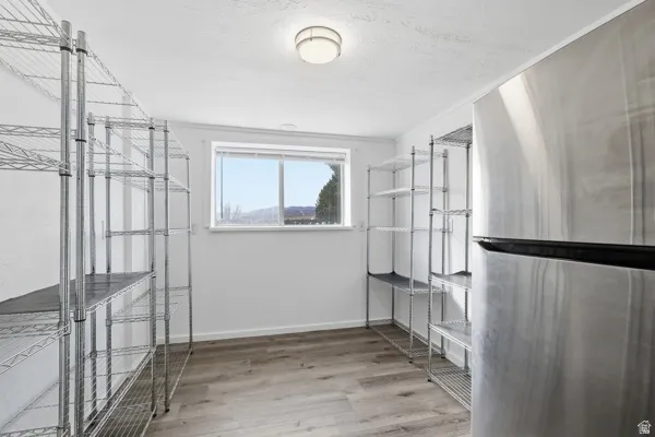 Walk in storage closet/pantry  featuring light wood finished floors