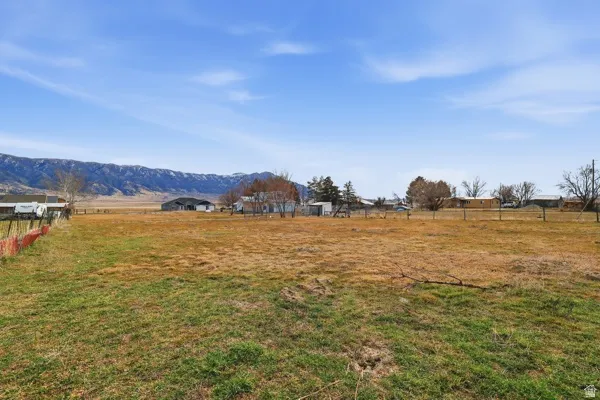 View of yard with a rural view and a mountain view