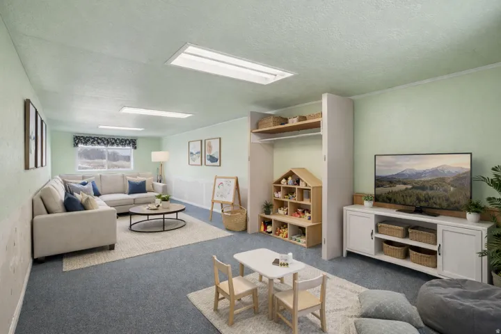 Living room featuring carpet and a textured ceiling