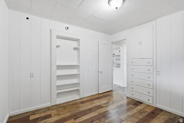 Unfurnished bedroom featuring dark wood-style flooring