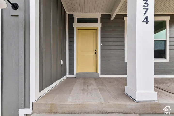 Property entrance with covered porch