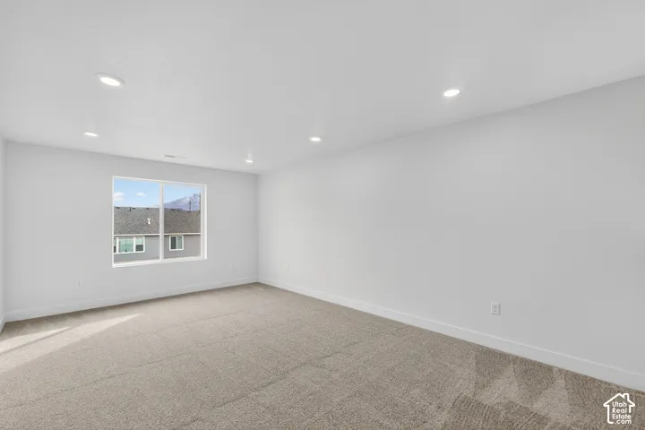 Unfurnished room with carpet floors and recessed lighting