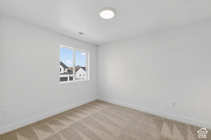Unfurnished room featuring baseboards and carpet flooring