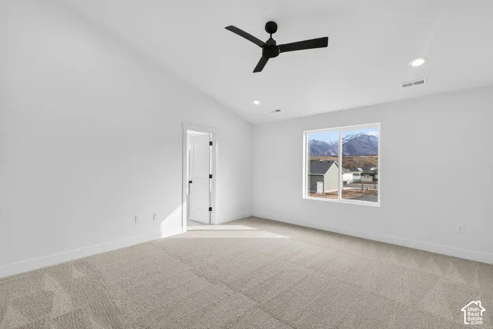 Carpeted empty room with ceiling fan, lofted ceiling, and recessed lighting