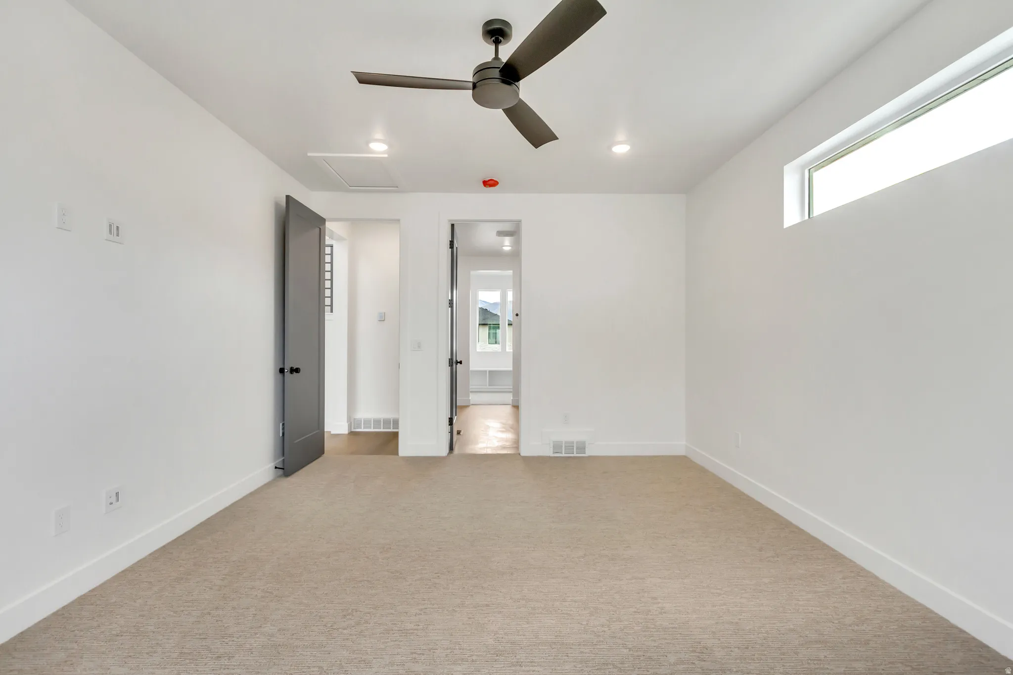Unfurnished bedroom featuring light carpet, a ceiling fan, and recessed lighting