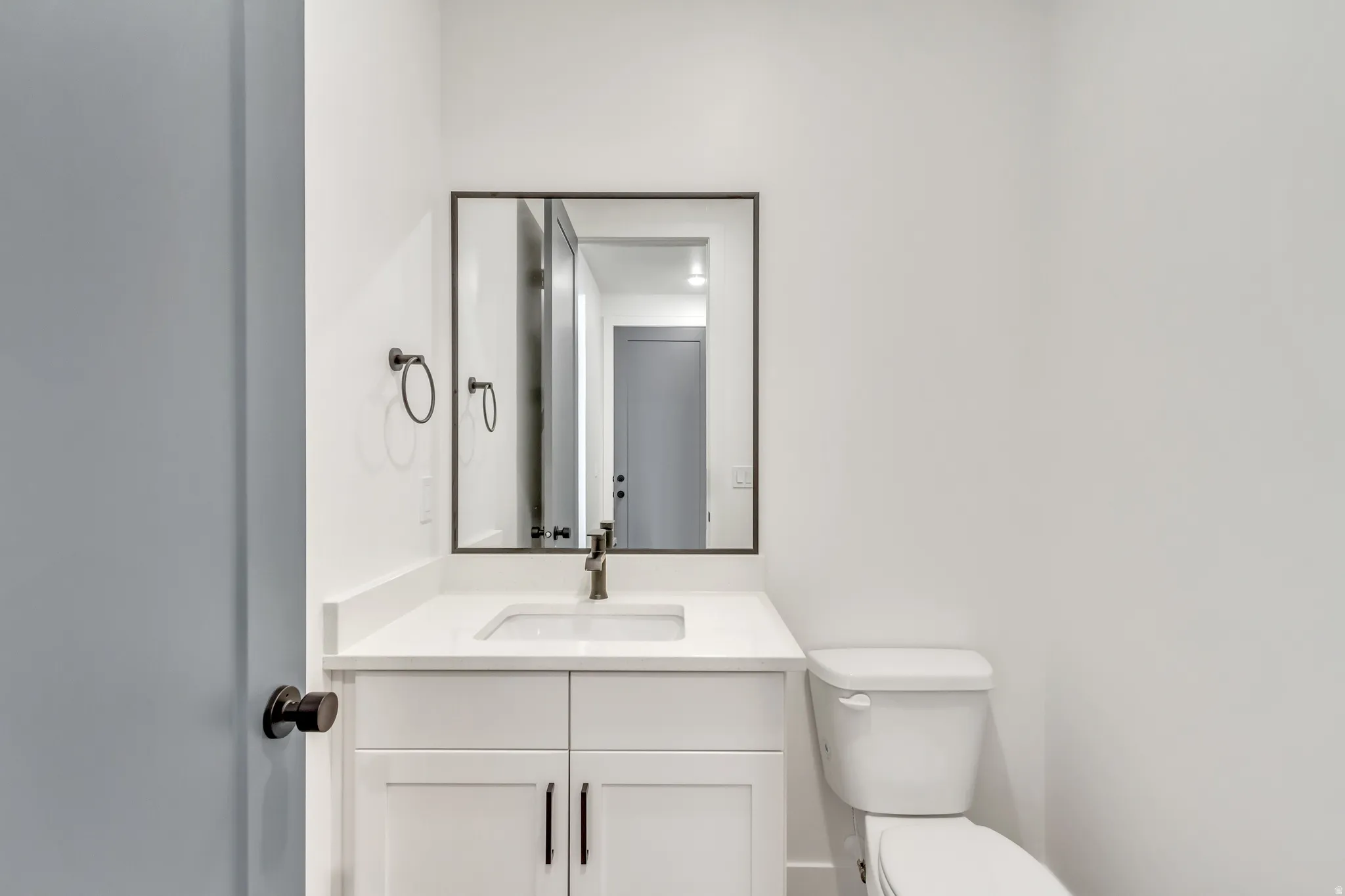 Half bath featuring vanity and toilet