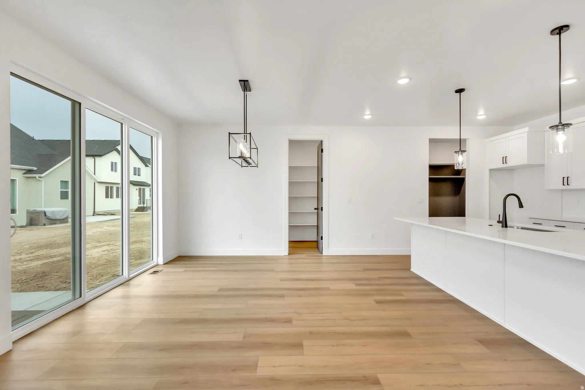 Unfurnished dining area featuring light wood finished floors and recessed lighting