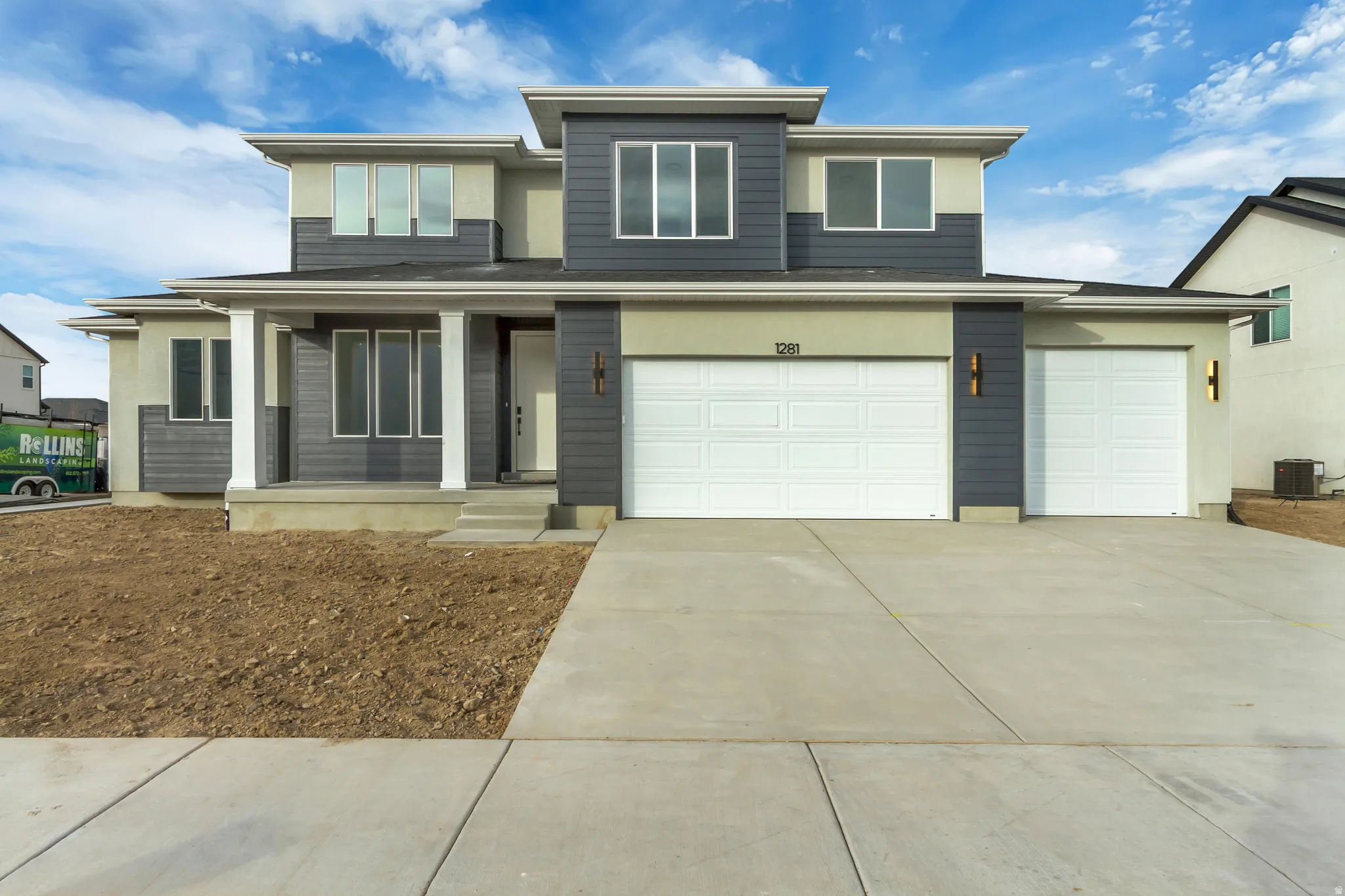 View of front of home with driveway, covered porch, an attached garage, and stucco siding
