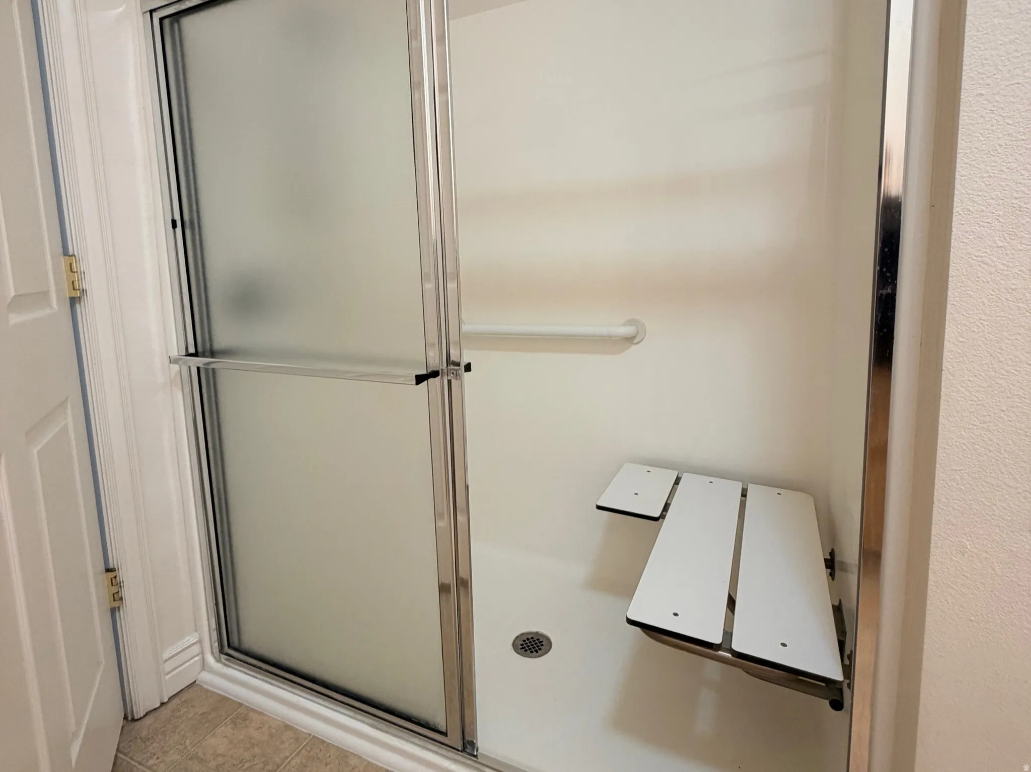 3/4 bathroom with walk-In shower with a bench