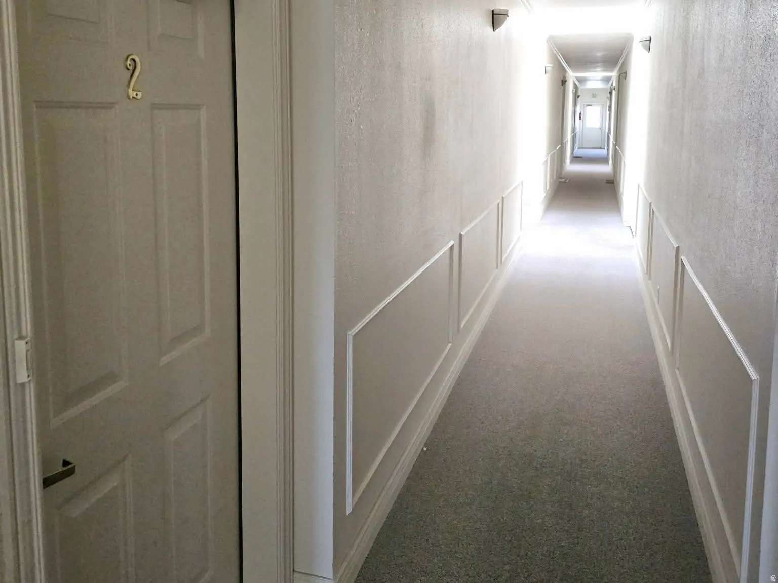 View of the door and hallway from the inside entrance of the condo