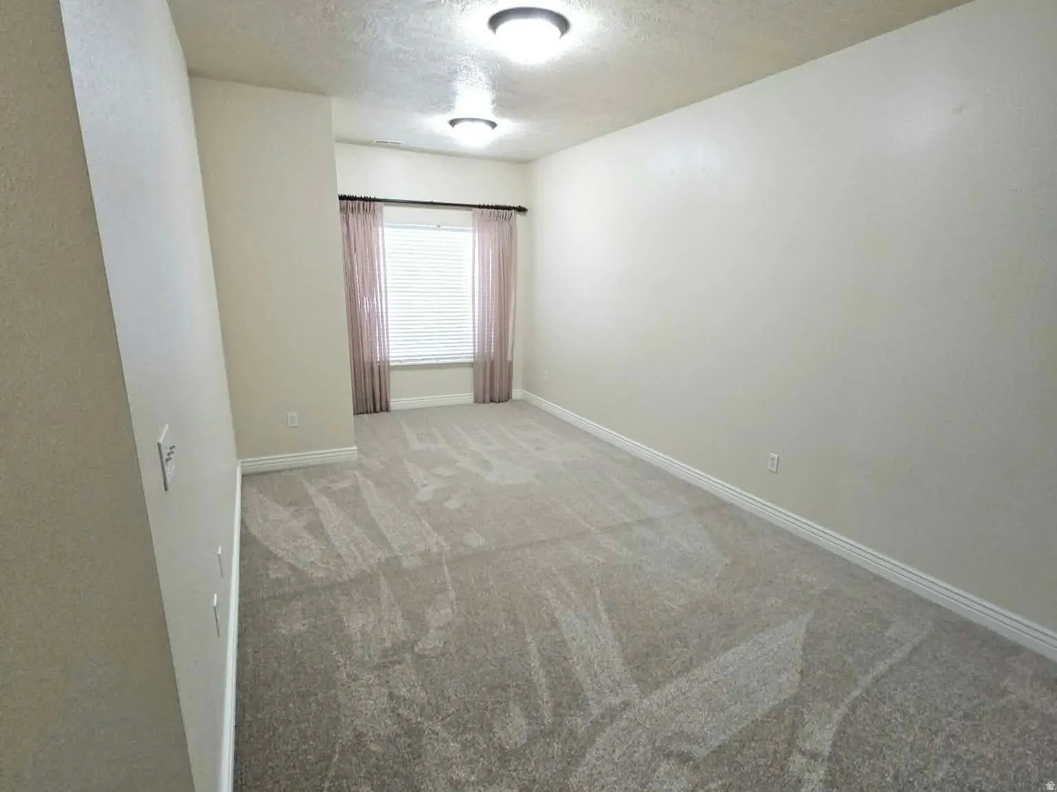 Plenty of room in the primary bedroom along with new carpet