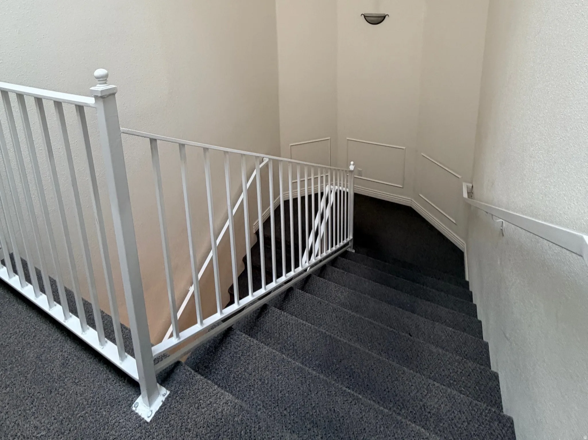 The stairs leading to the parking garage from the hallway