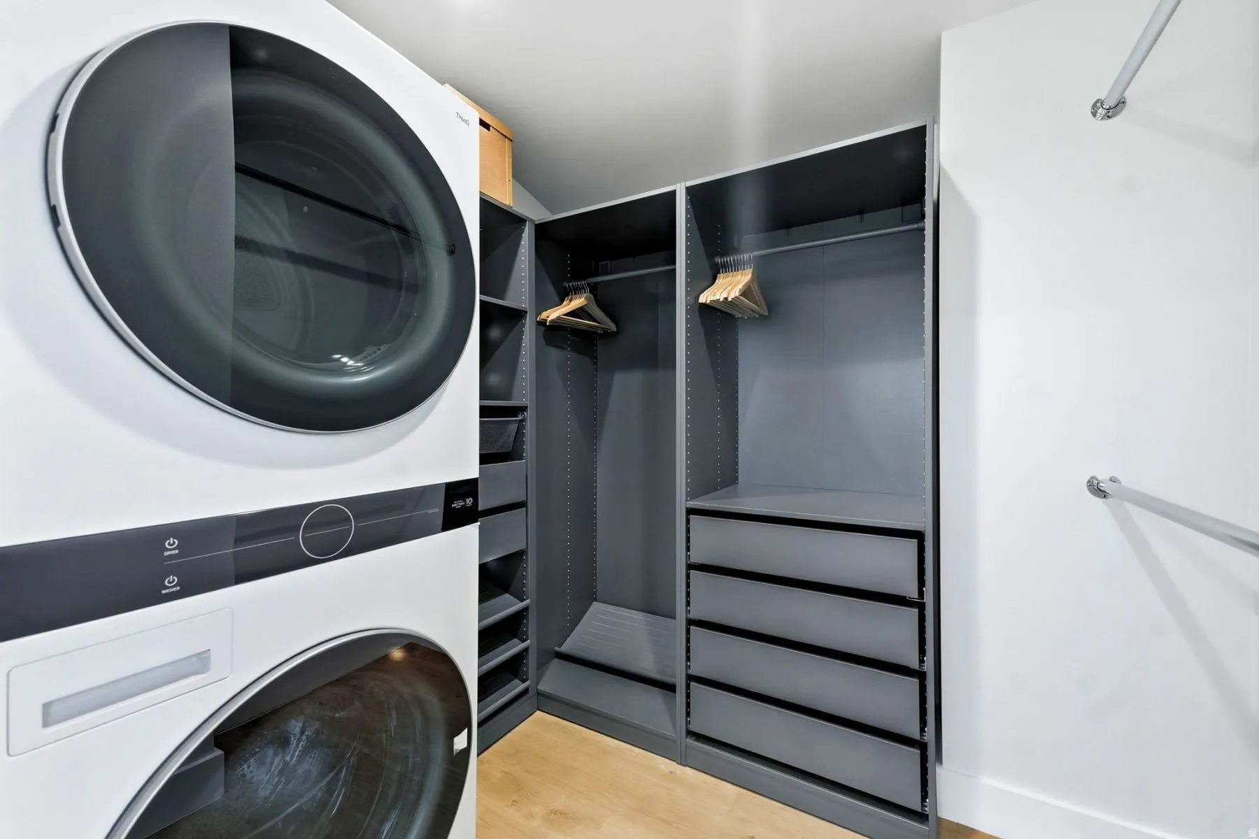 Laundry area with stacked washing machine and dryer