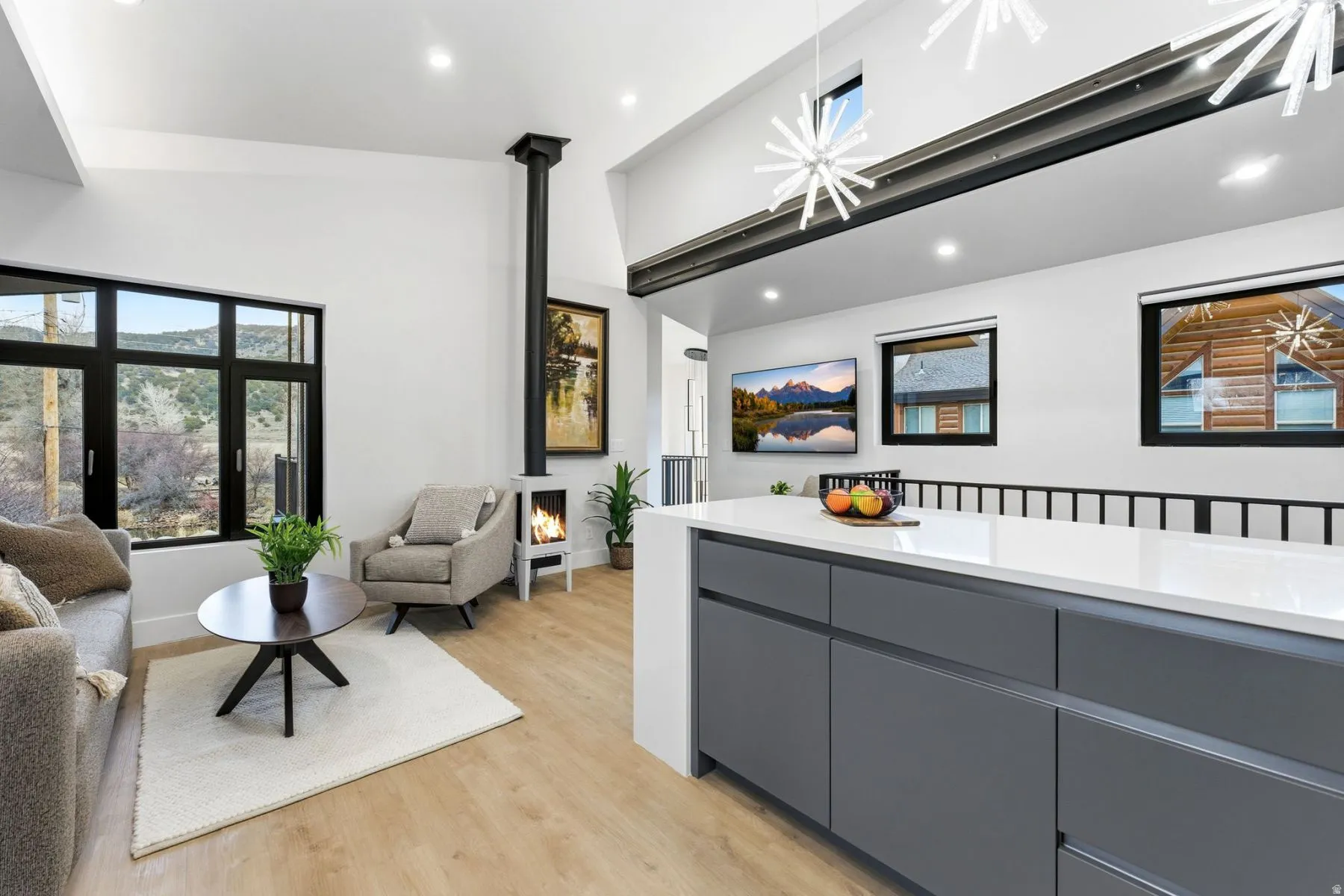 Living area featuring light wood finished floors, recessed lighting, and vaulted ceiling