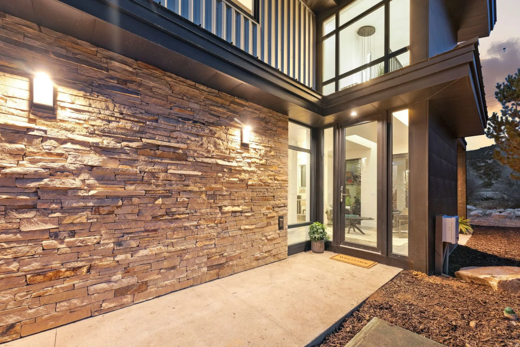 Doorway to property with a patio area