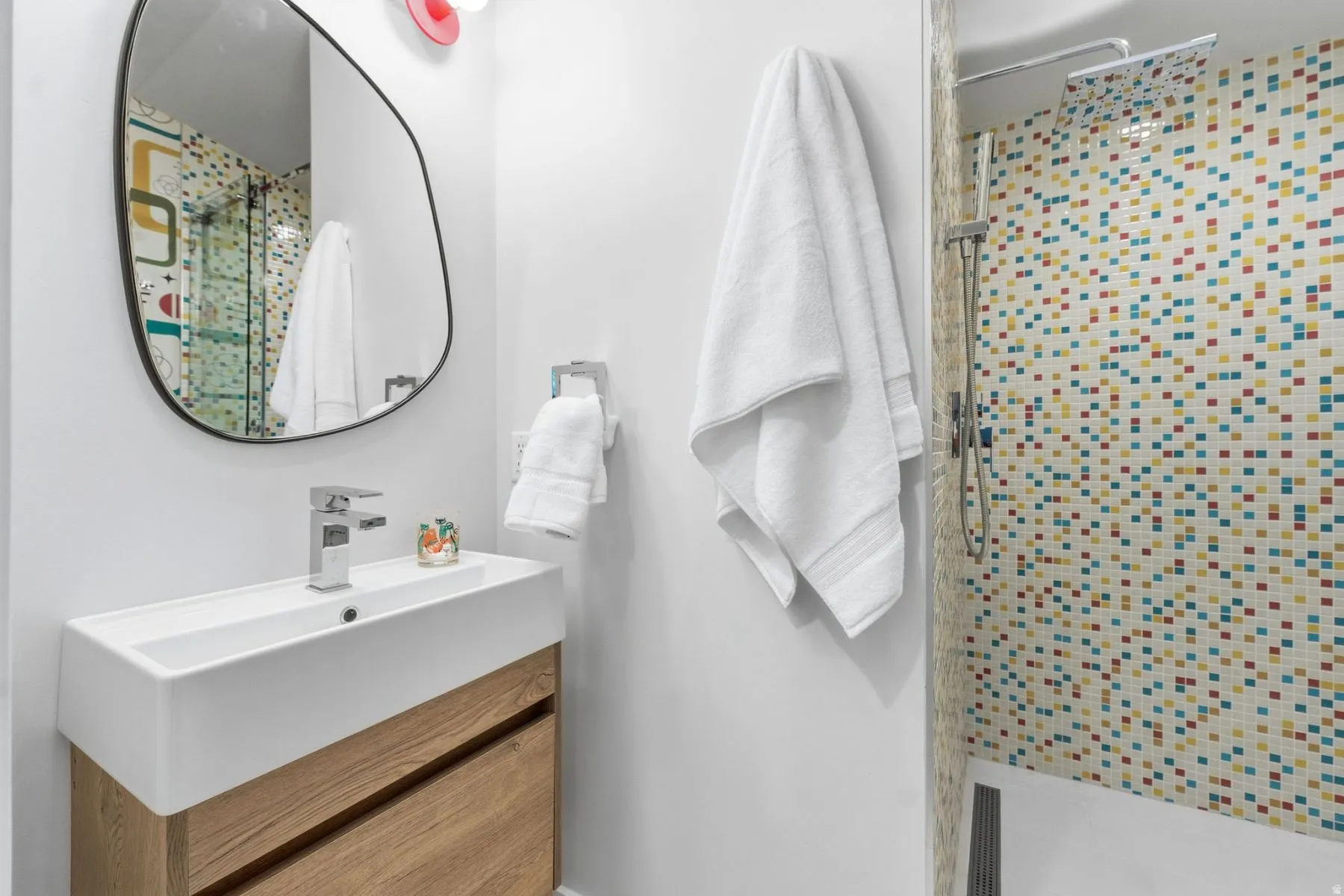 Full bath with a shower stall and vanity