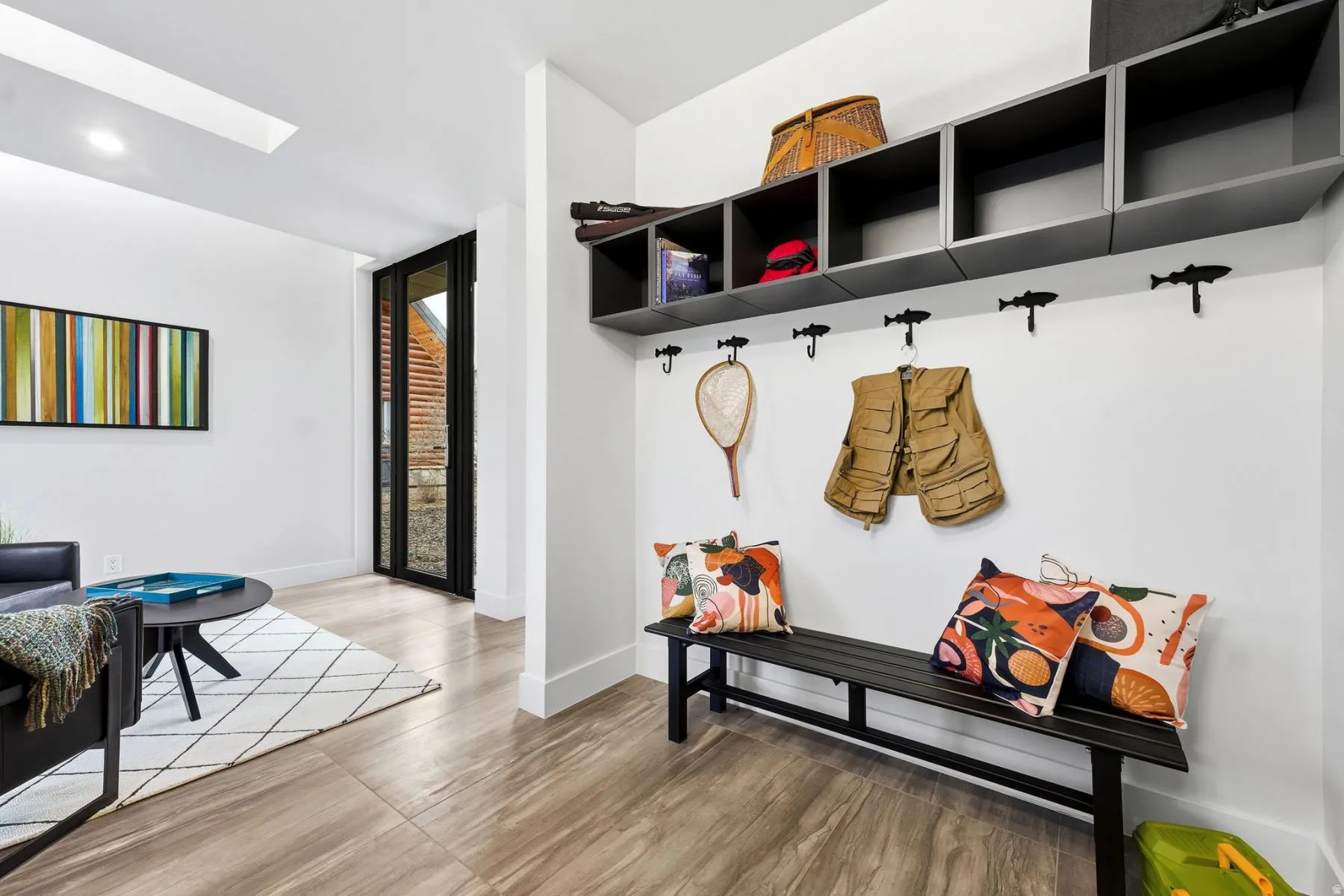 Mudroom featuring wood finished floors, a skylight, and recessed lighting