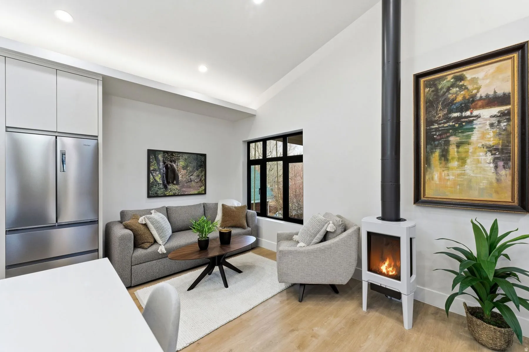 Living room with light wood-type flooring, lofted ceiling, and recessed lighting