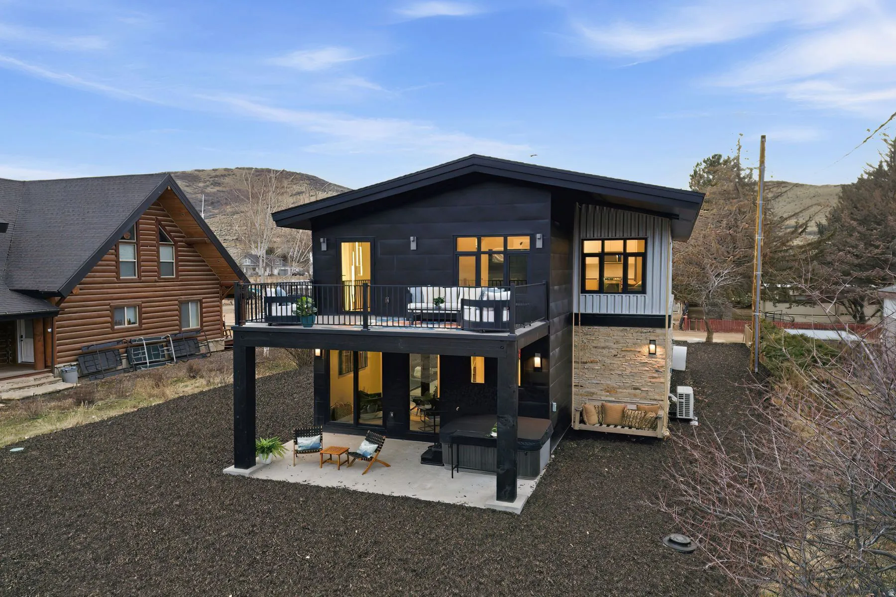 Rear view of house featuring a patio, board and batten siding, and a deck with mountain view