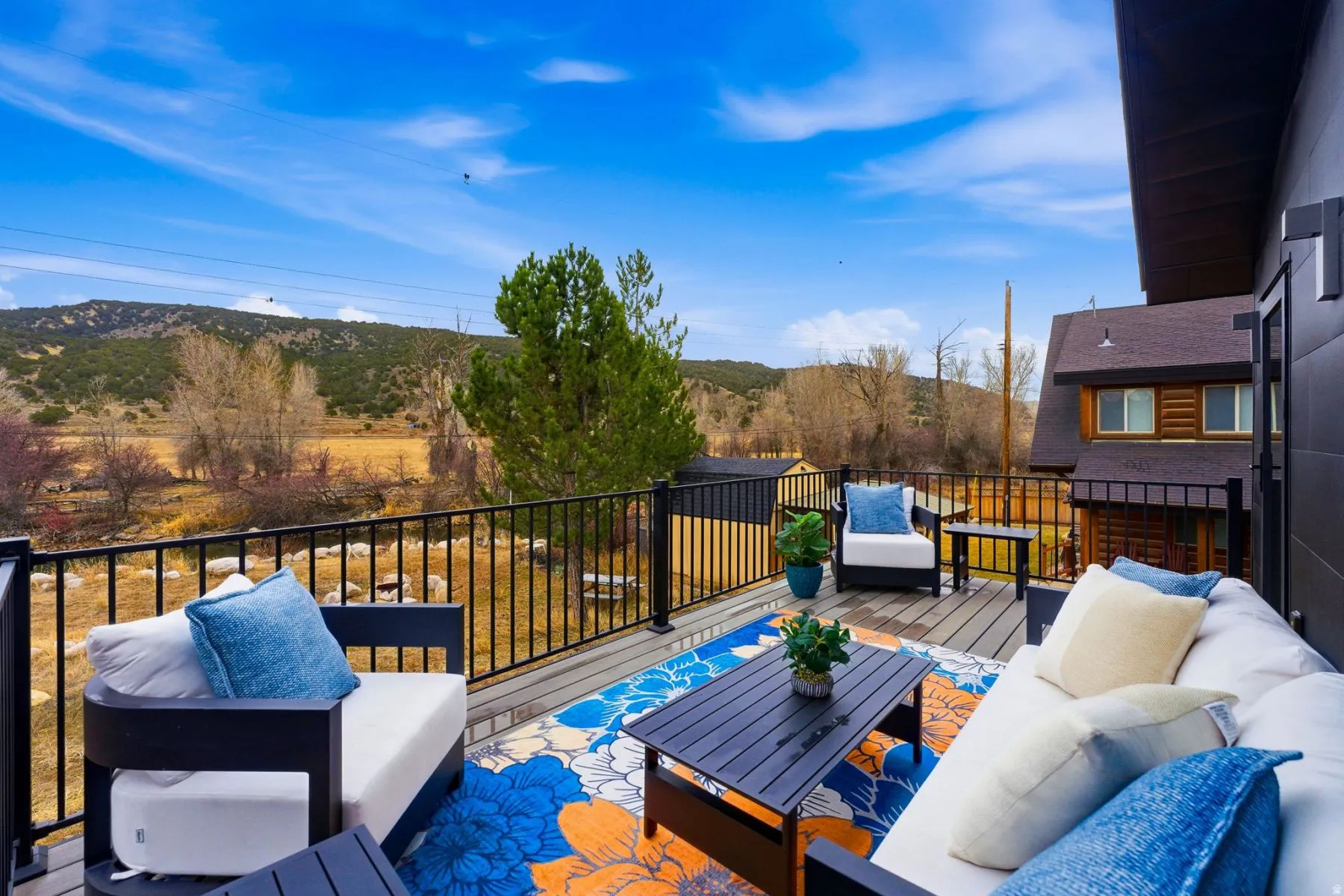 Wooden deck with outdoor lounge area and a mountain view