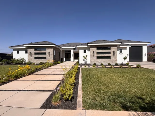 Contemporary architecture featuring a white stucco exterior and stone accents
