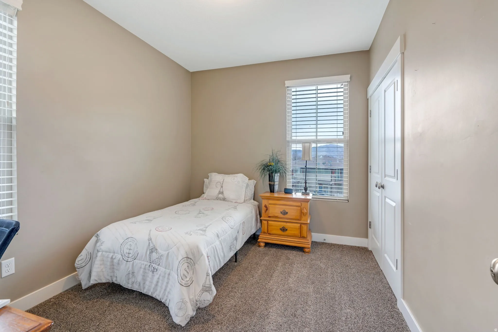 Carpeted bedroom featuring baseboards and a closet
