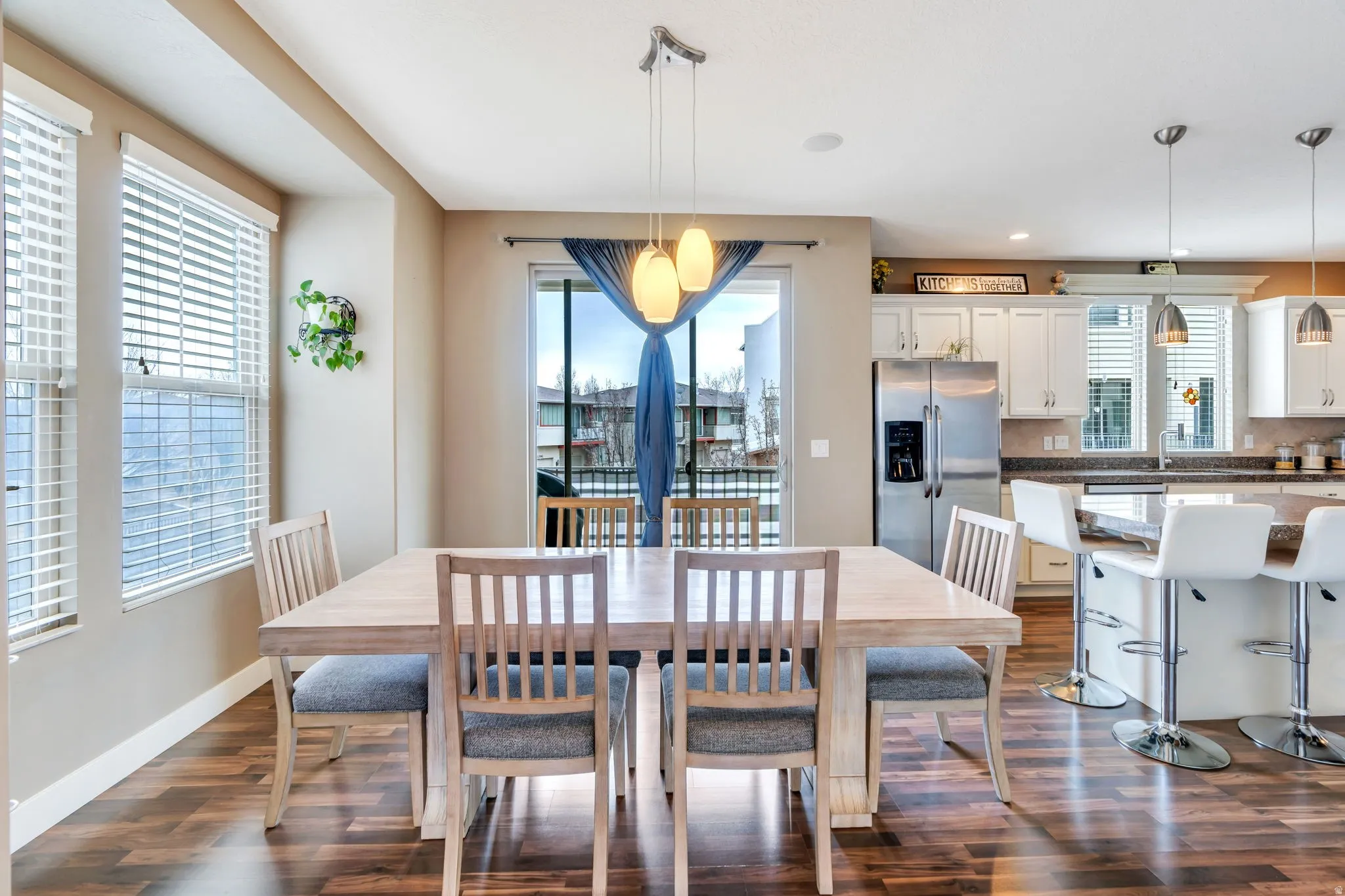 Dining room with dark wood-style floors and baseboards