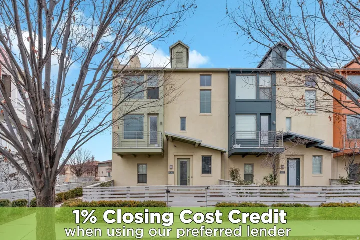 View of front of house featuring stucco siding, a fenced front yard, and a balcony